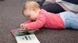Child looking at book.