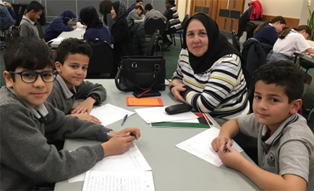 Palestinian students writing in Arabic.