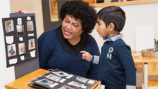 Teacher and student looking at photos.