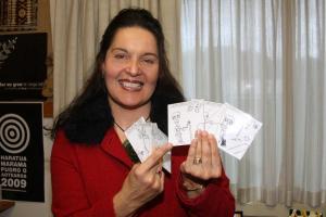 Teacher holding picture cards.